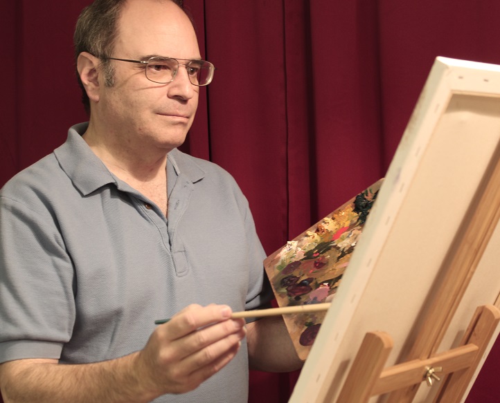 photo of artist painting at his easel