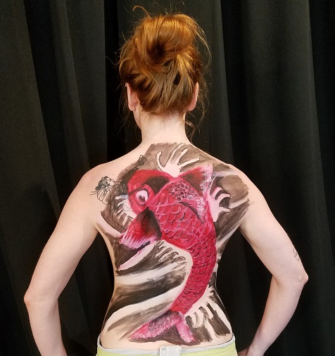 body painting of Koi fish on the back of female nude