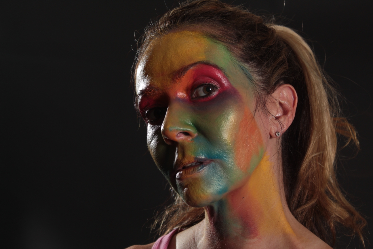 female face painted in multiple colors