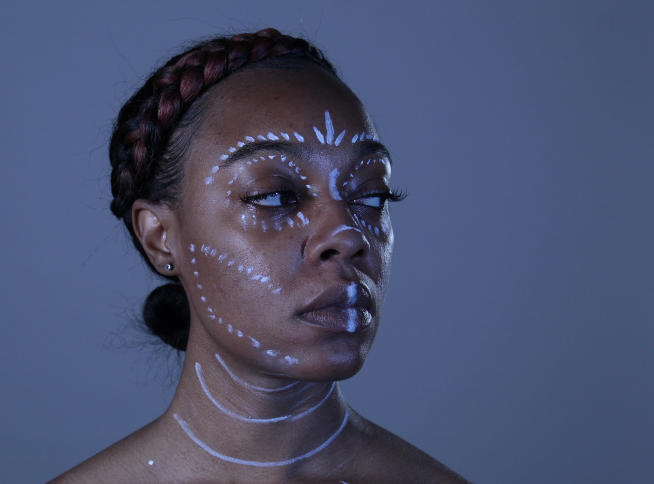 body painting white tribal lines on black female