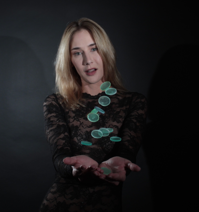female model tossing green plastic disks in the air
