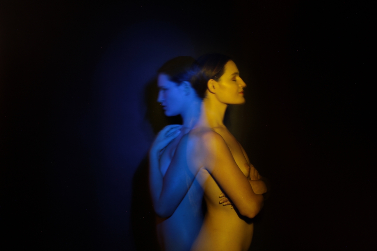 double exposure of topless model, one blue and one yellow