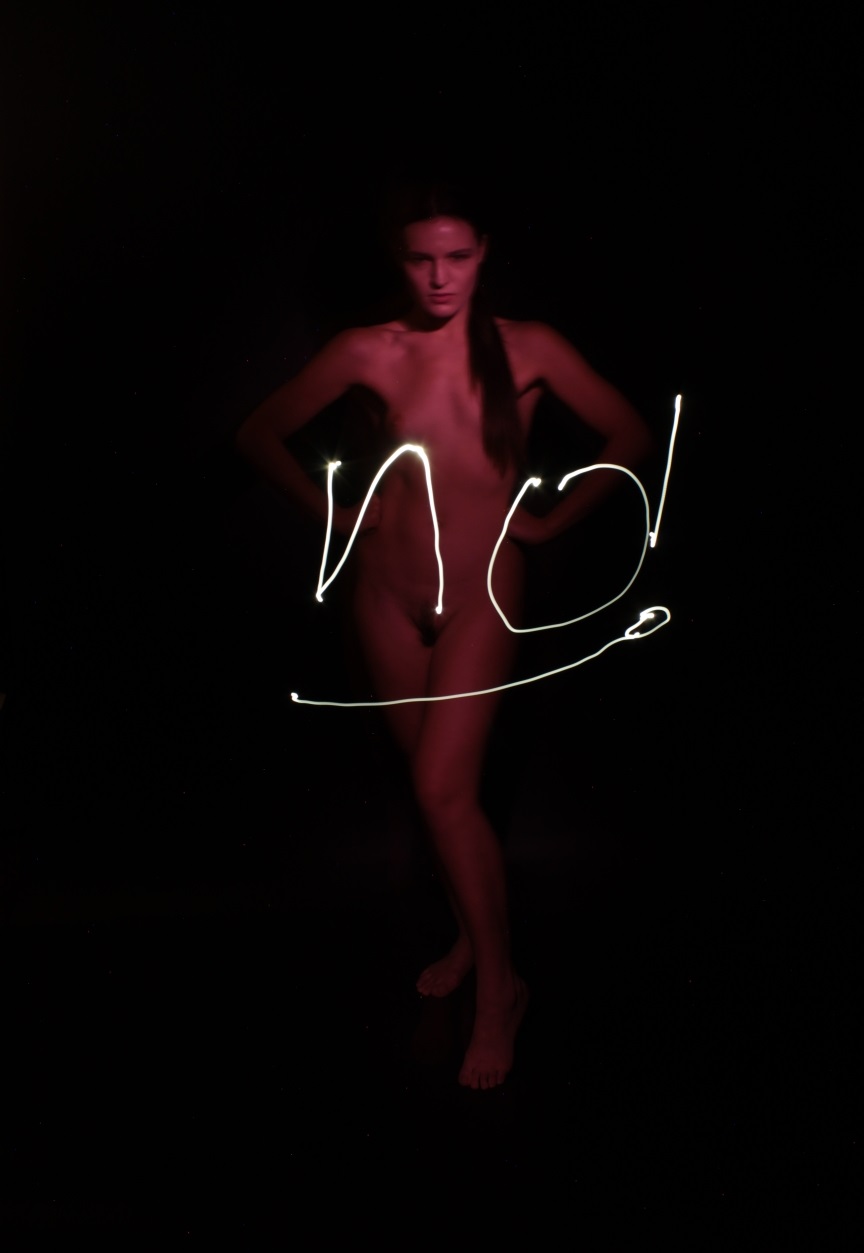 light painting of nude female lit in red with light drawn word NO.