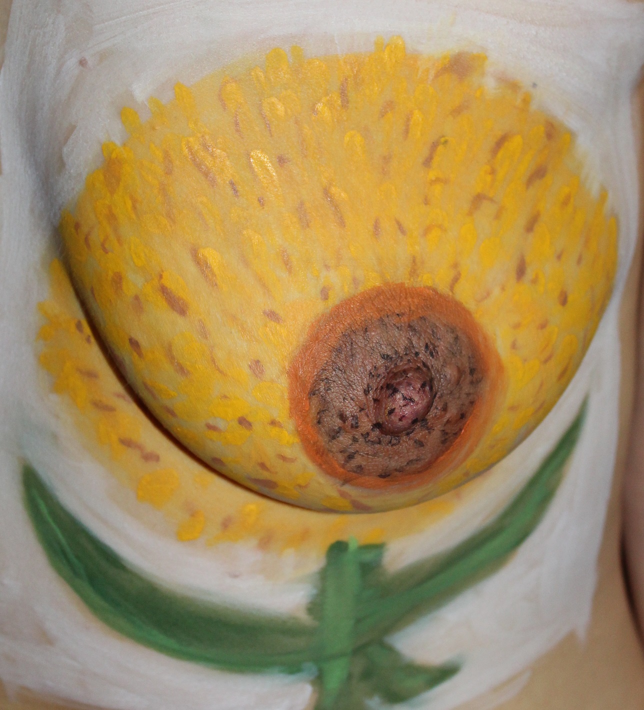 body painting sunflower on female left breast