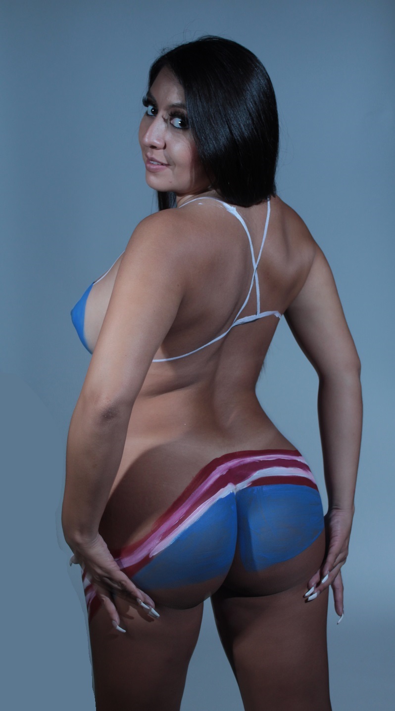 Back view of nude model painted with American Flag across bottom with a Blue, White and Red bikini straps