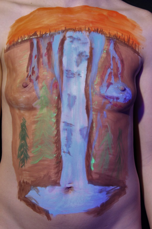 Waterfall in U V body paint on female torso under day light