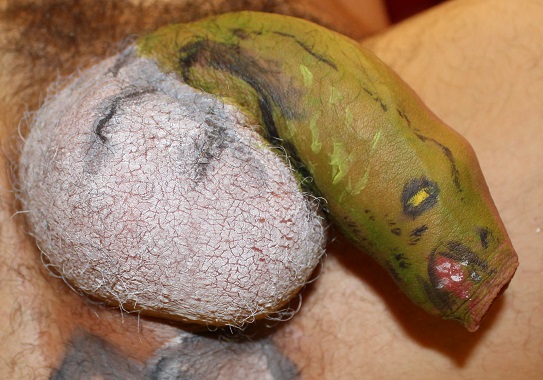 body painting of lizzard coming out of an egg, egg is scrotum and lizzard is penis